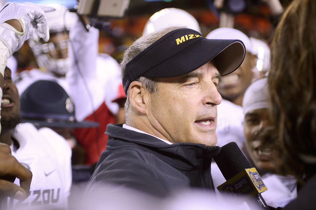 Players surround Gary Pinkel during SEC interview